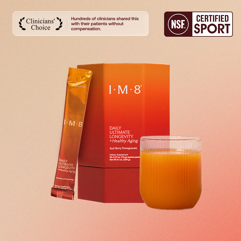 IM8 Daily Ultimate Longevity orange product box and sachet beside a prepared orange drink