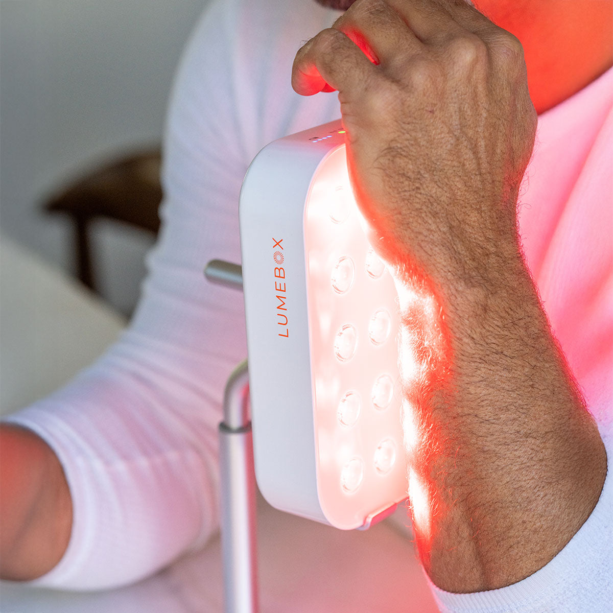 LUMEBOX 2.0 portable red light therapy device in use